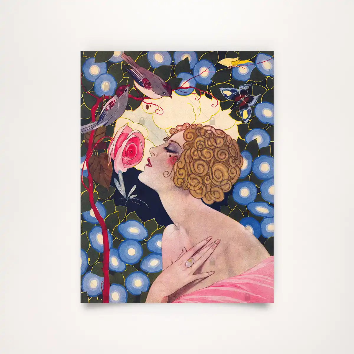 Colorful vintage illustration titled Spring Magic from Reigen Magazine, 1925. The image shows the profile of an elegant woman with golden curls smelling a pink rose, surrounded by blue blossoms and birds in magnificent Art Deco style.